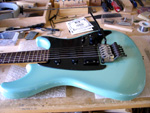 image of a guitar on the repair bench